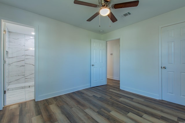 unfurnished bedroom featuring ceiling fan, connected bathroom, and dark hardwood / wood-style flooring