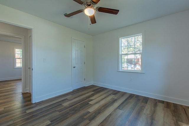 empty room featuring ceiling fan and dark hardwood / wood-style flooring