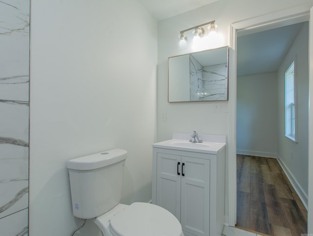 bathroom featuring vanity, hardwood / wood-style floors, and toilet