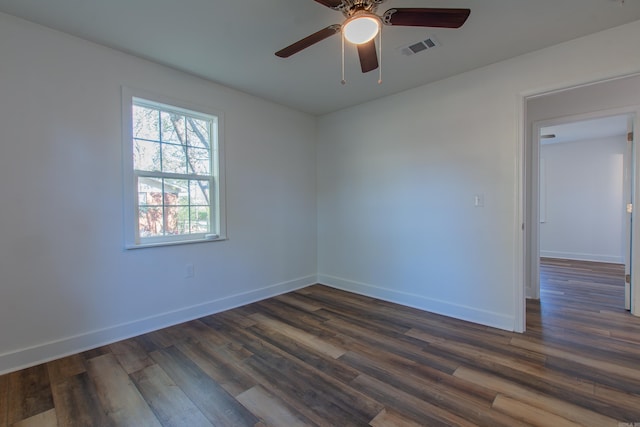 empty room with dark hardwood / wood-style flooring and ceiling fan