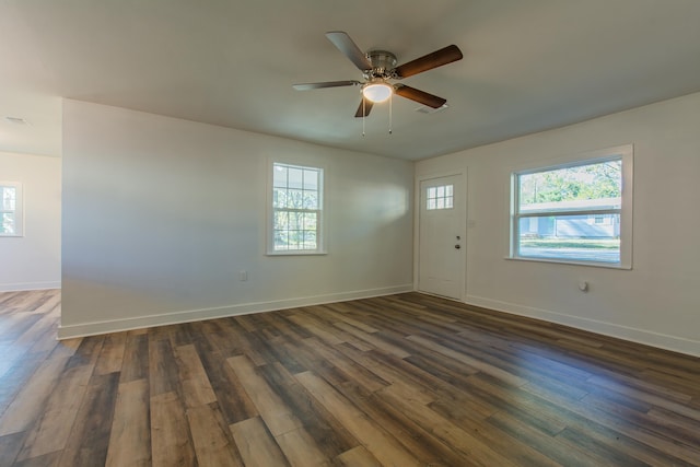 unfurnished room with dark hardwood / wood-style flooring, ceiling fan, and a healthy amount of sunlight