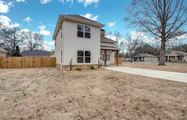 rear view of house with a yard