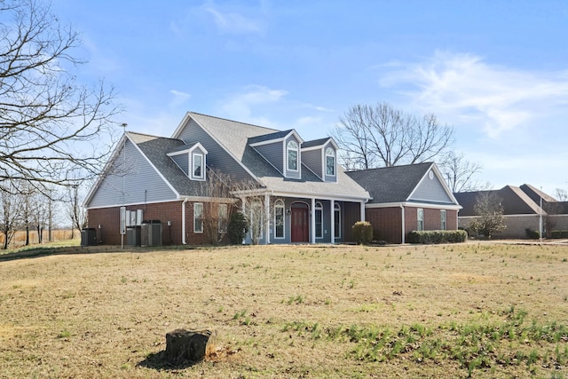 cape cod-style house with cooling unit and a front yard