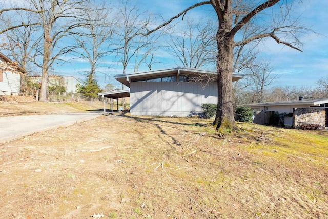 view of side of property with a carport