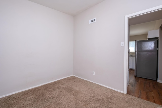 empty room featuring dark colored carpet