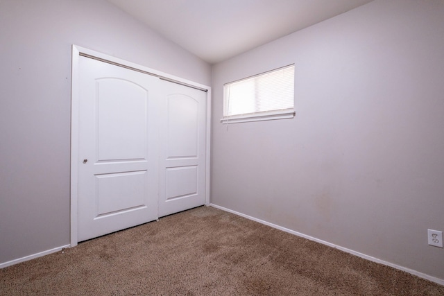 unfurnished bedroom featuring carpet floors and a closet