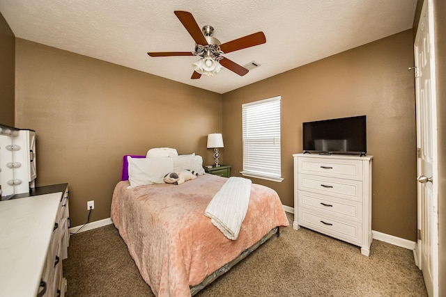 bedroom featuring a textured ceiling, carpet floors, and ceiling fan