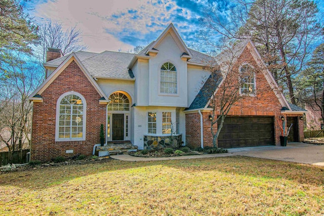 view of front of house with a garage and a lawn