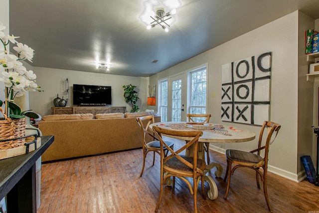 dining room featuring wood-type flooring and french doors