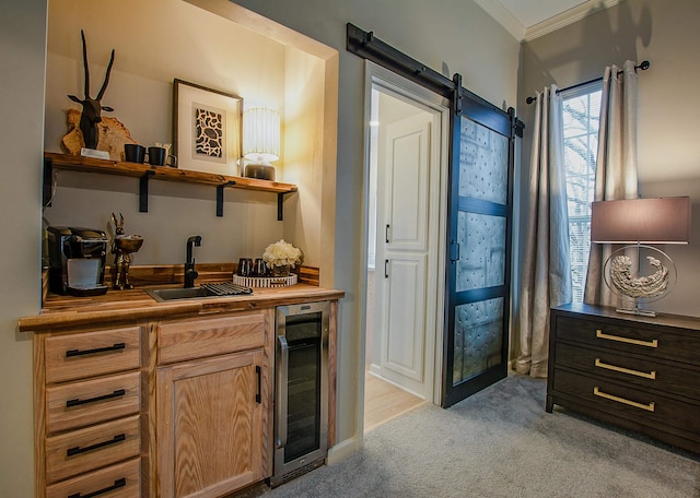 bar featuring wine cooler, sink, crown molding, light colored carpet, and a barn door