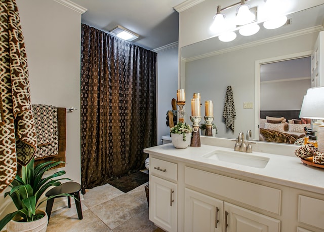 bathroom with tile patterned flooring, ornamental molding, vanity, and toilet