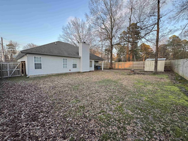 rear view of house with a storage unit