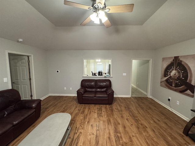 living room featuring a tray ceiling, ceiling fan, and hardwood / wood-style flooring