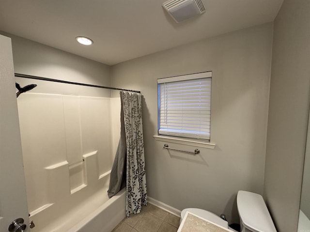 bathroom with shower / tub combo, tile patterned floors, and toilet