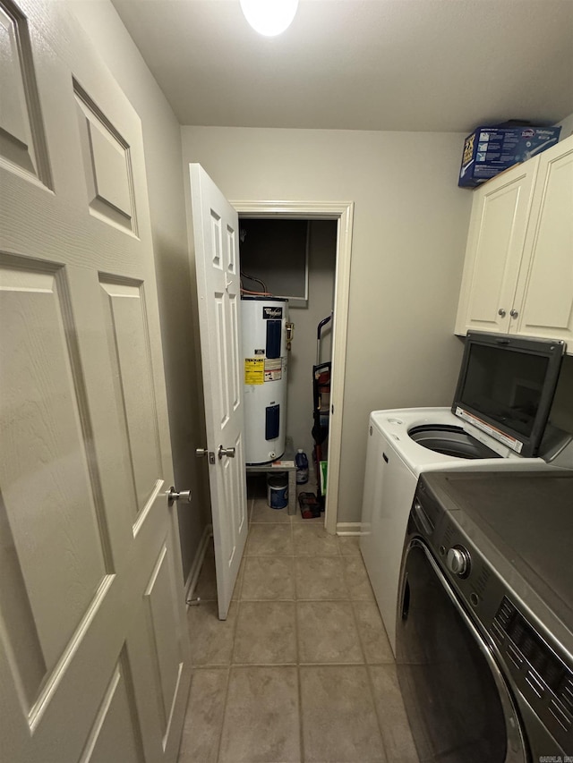 laundry room featuring cabinets, light tile patterned floors, washing machine and dryer, and water heater