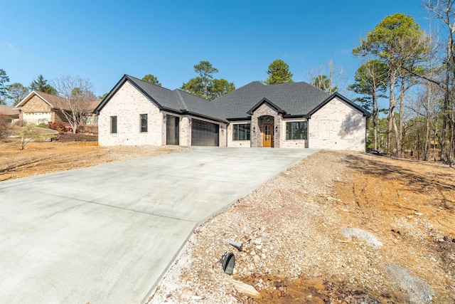 french provincial home featuring a garage