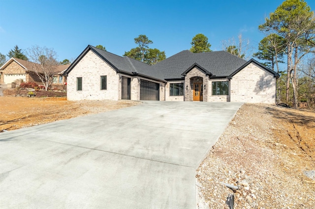 french provincial home featuring a garage