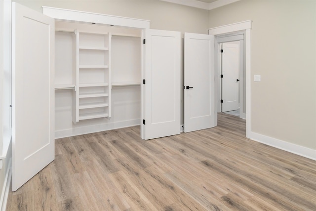 unfurnished bedroom with light hardwood / wood-style flooring and a closet