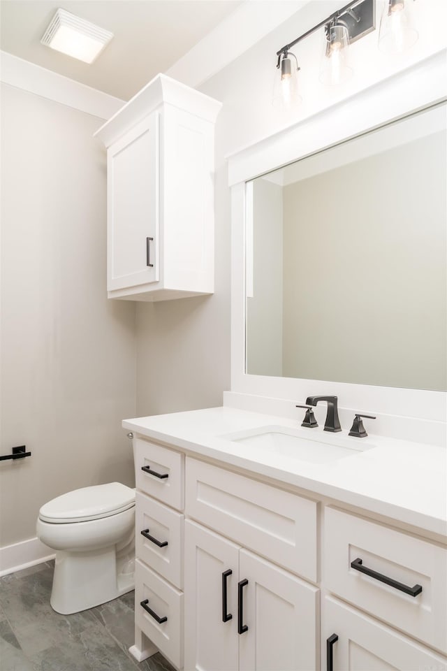 bathroom featuring vanity and toilet