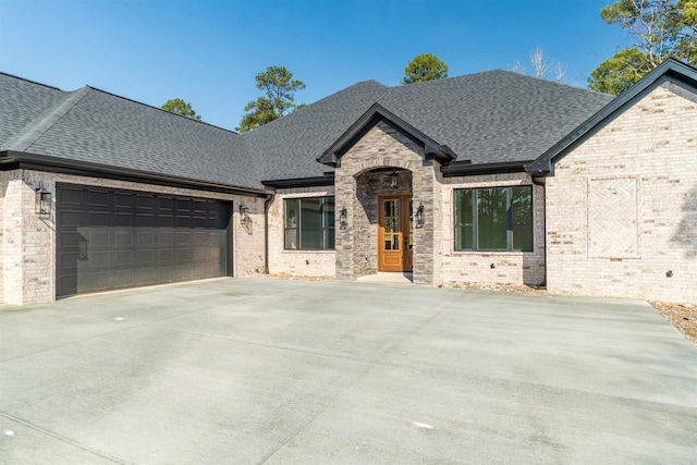 french country inspired facade with a garage