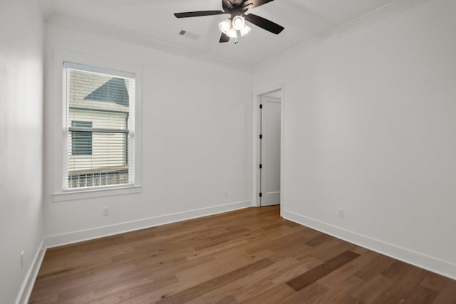 spare room with hardwood / wood-style flooring, ornamental molding, and ceiling fan