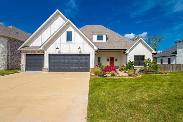 modern inspired farmhouse featuring a garage and a front lawn