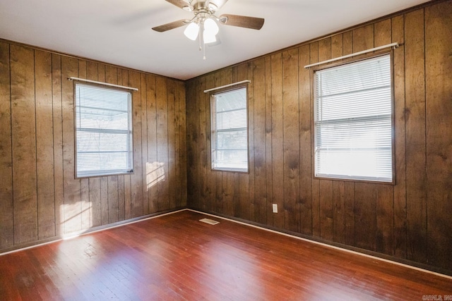 spare room with ceiling fan and dark hardwood / wood-style floors