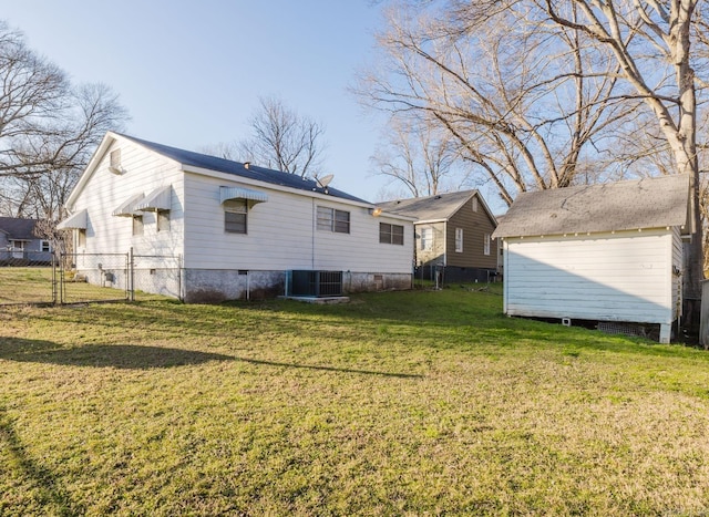 back of house with a yard and central AC unit