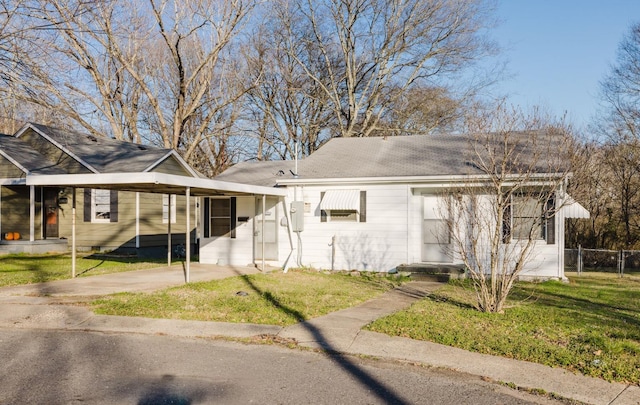 view of front facade with a front yard and a carport