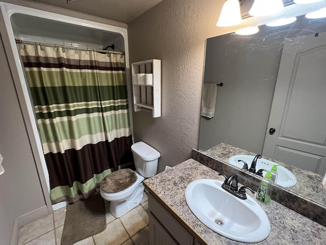 bathroom with a shower with curtain, vanity, toilet, and tile patterned flooring