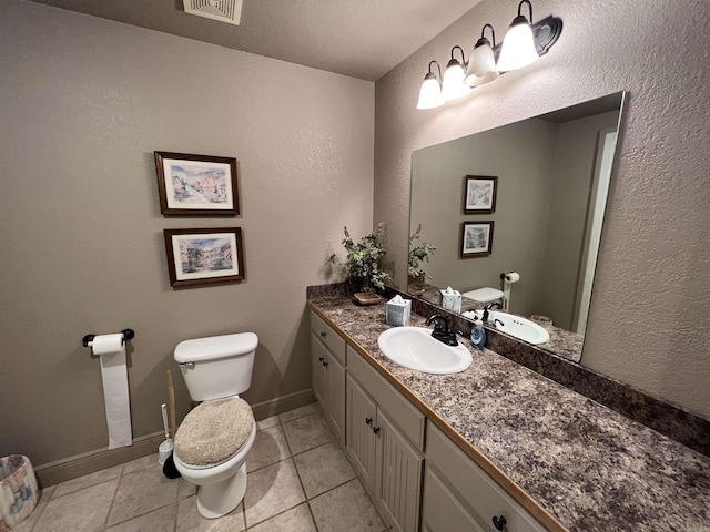 bathroom with vanity, tile patterned floors, and toilet