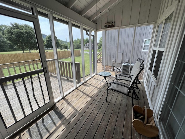 sunroom / solarium featuring lofted ceiling with beams and wood ceiling