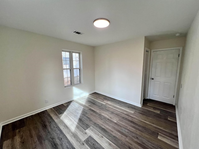 unfurnished room featuring dark hardwood / wood-style flooring
