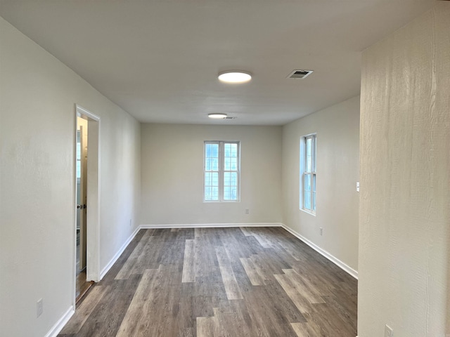 spare room with dark hardwood / wood-style floors