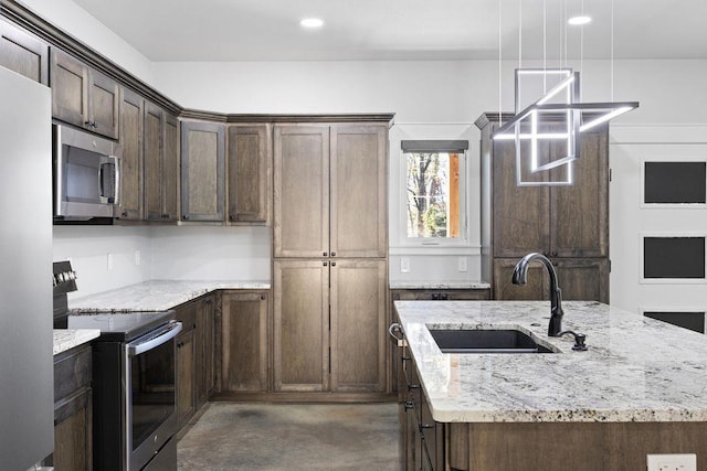 kitchen with decorative light fixtures, sink, dark brown cabinetry, stainless steel appliances, and light stone countertops