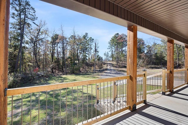 wooden deck featuring a lawn