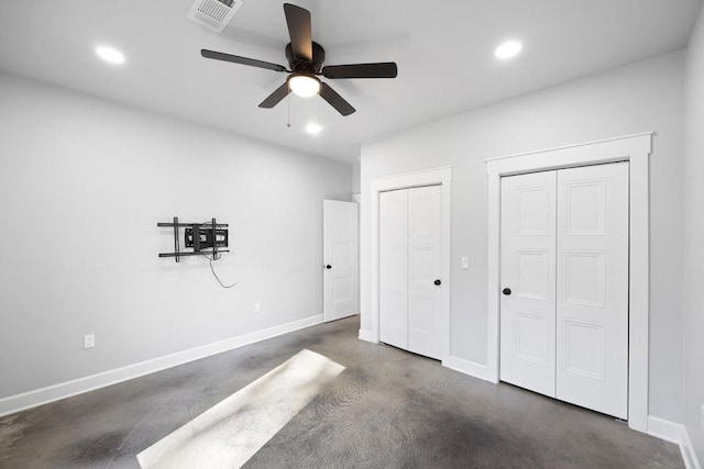 unfurnished bedroom with two closets and ceiling fan