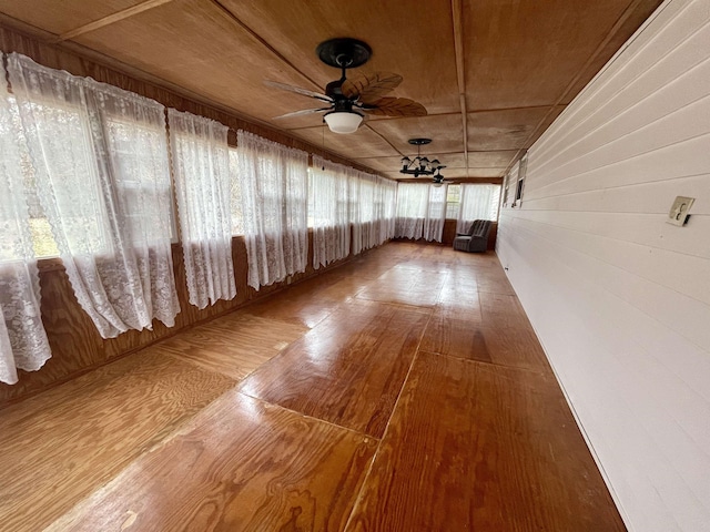 unfurnished sunroom featuring ceiling fan