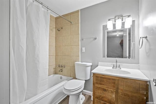 full bathroom with vanity, shower / bath combo with shower curtain, and toilet