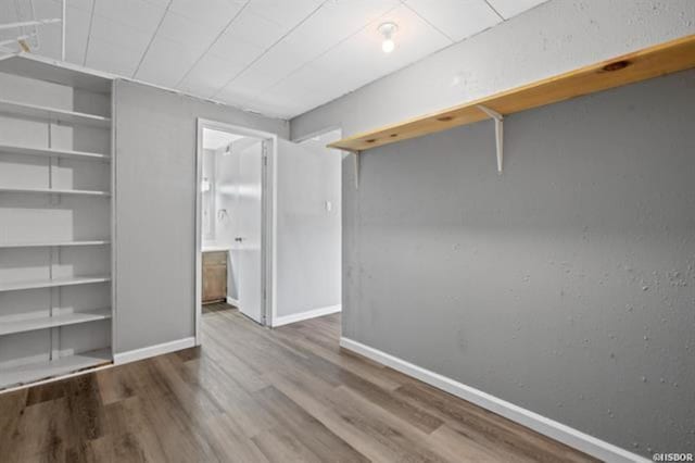 interior space featuring connected bathroom and hardwood / wood-style flooring