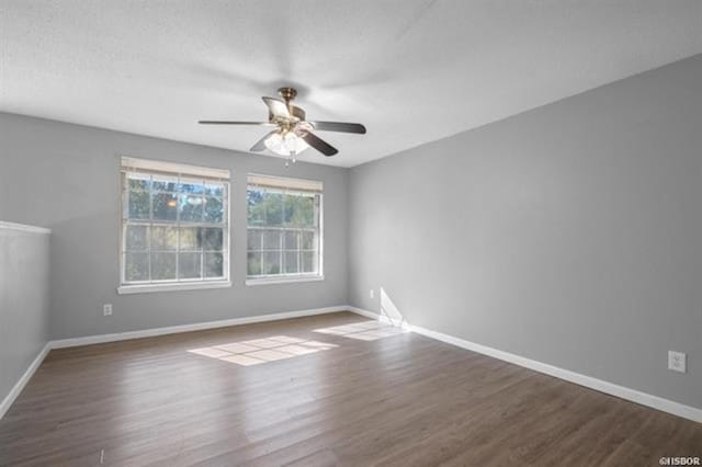 unfurnished room with dark hardwood / wood-style floors and ceiling fan