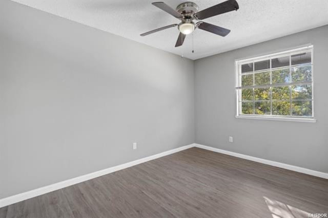 unfurnished room with ceiling fan, dark hardwood / wood-style floors, and a textured ceiling