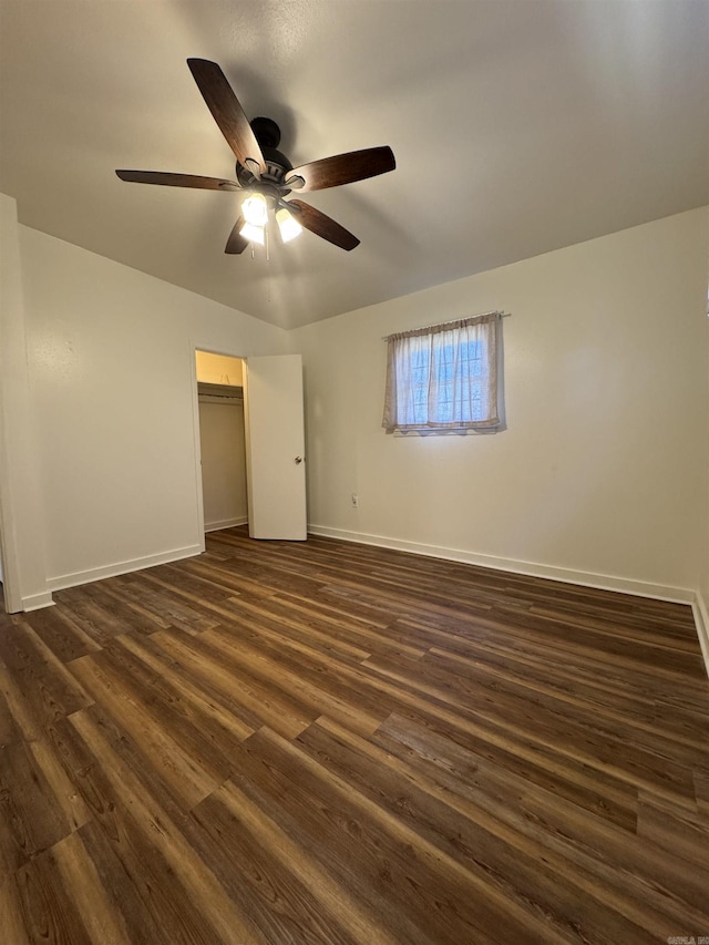 unfurnished bedroom with ceiling fan, dark hardwood / wood-style floors, and a closet