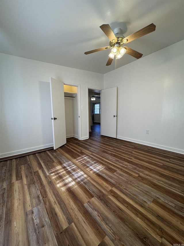 unfurnished bedroom with ceiling fan and dark wood-type flooring