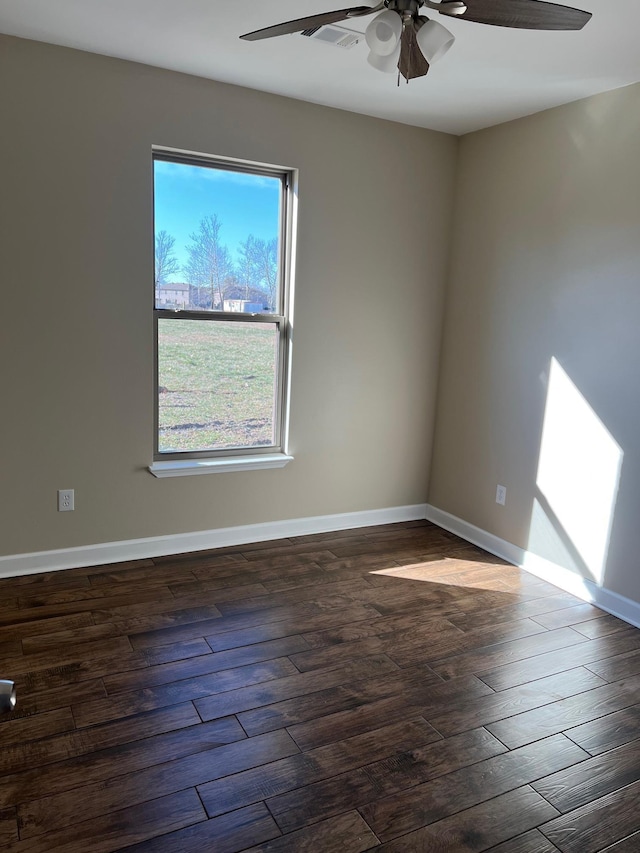 spare room featuring dark hardwood / wood-style floors and ceiling fan