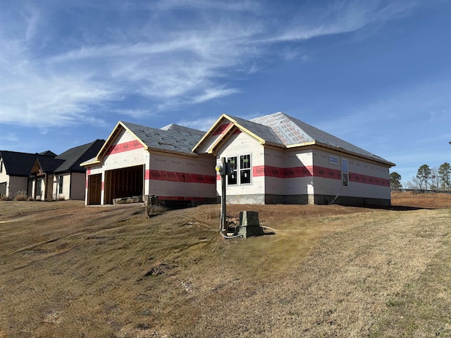 view of home's exterior featuring a garage and a yard