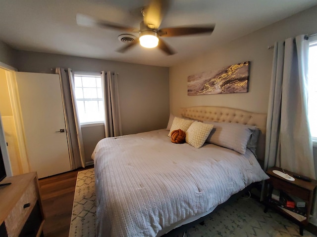 bedroom with hardwood / wood-style flooring and ceiling fan
