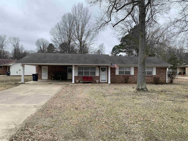 ranch-style home featuring a carport and a front yard