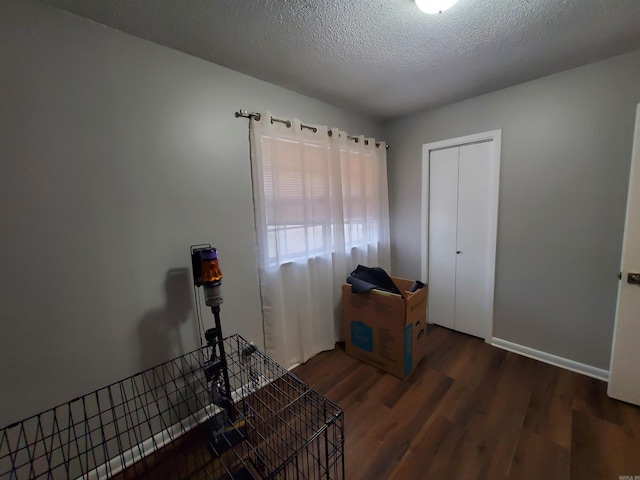 interior space featuring dark hardwood / wood-style floors and a textured ceiling
