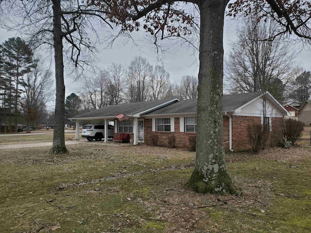 view of front of house with a front yard and a carport